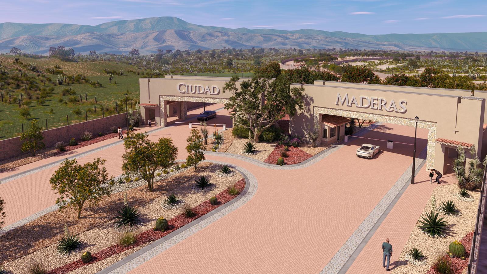 Entrance gate to Ciudad Maderas with two arched structures, cars, and landscaped surroundings in a mountainous area.