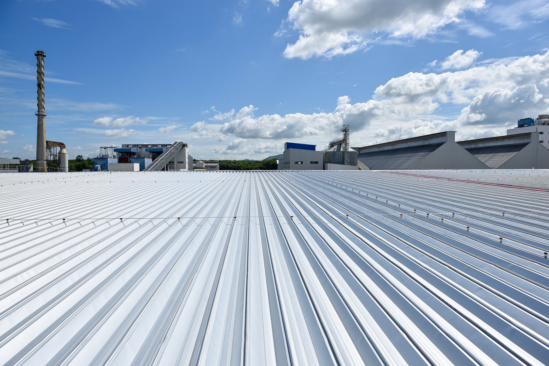 Roofing and lightning faraday systemon installed on new warehouse with exsiting old building warehouse and blue sky background