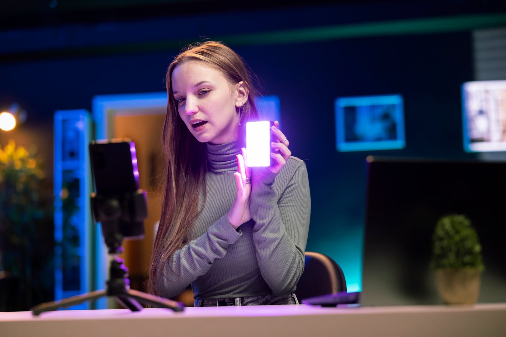 Teenage online show host being sponsored by partnering brand to do mini RGB lights unboxing video. Woman does influencer marketing, presenting viewers led production tool product