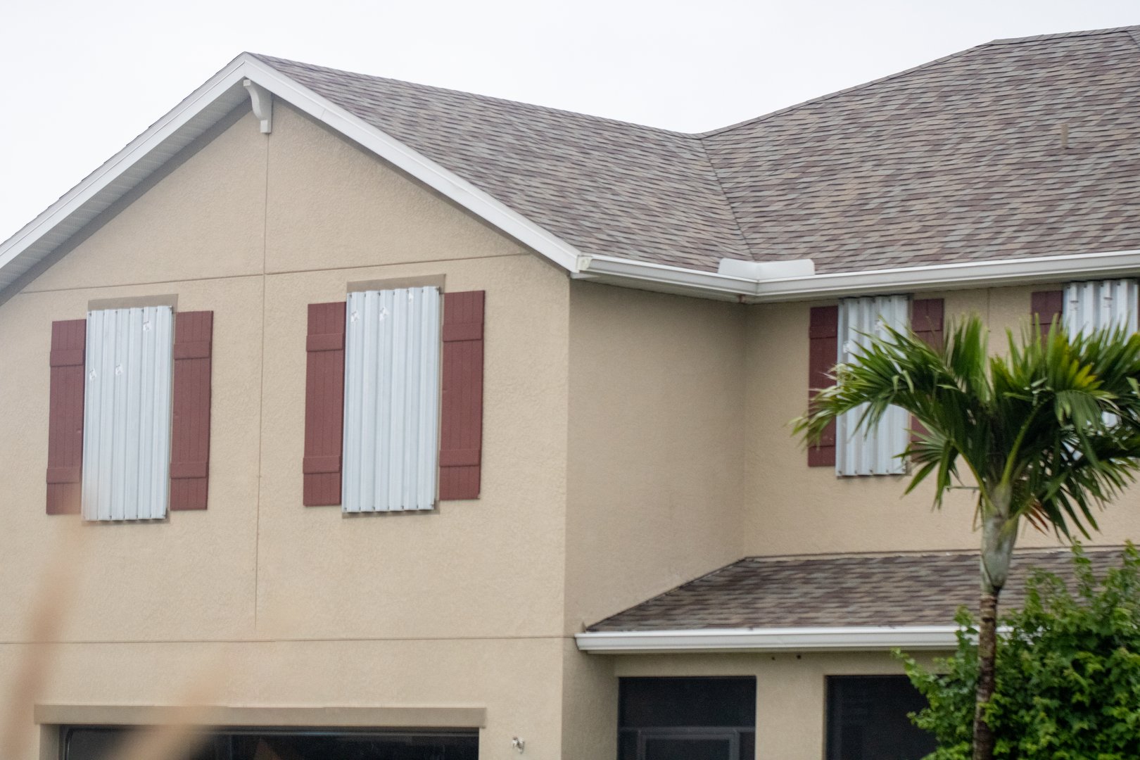 Two story house with shutters up pepared for a hurricane