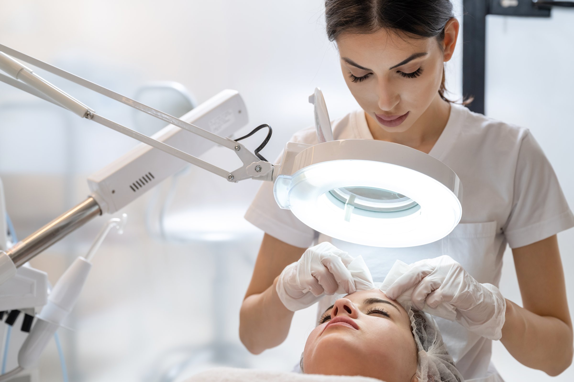 Professional facial treatment with light background
