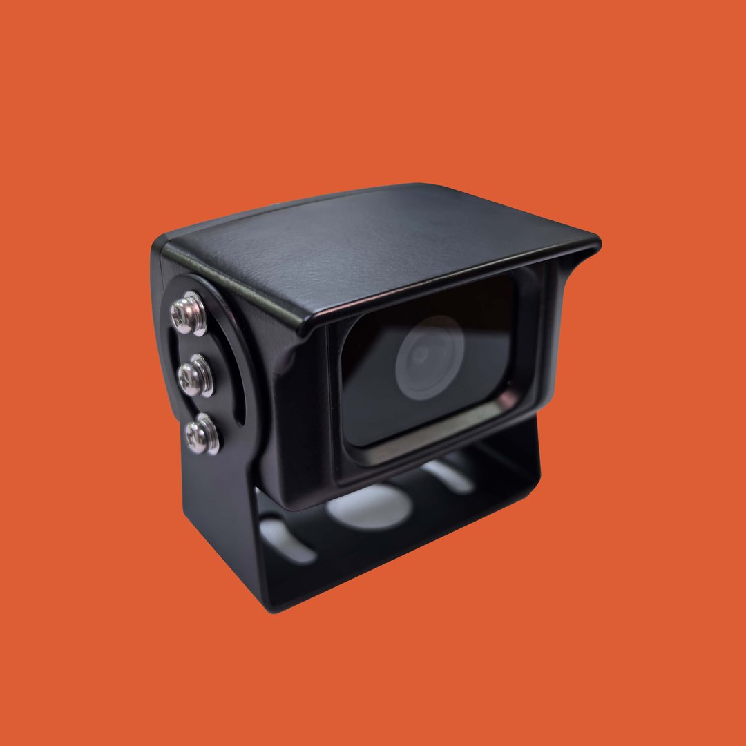A black rearview camera with a protective hood and three mounting screws on an orange background.
