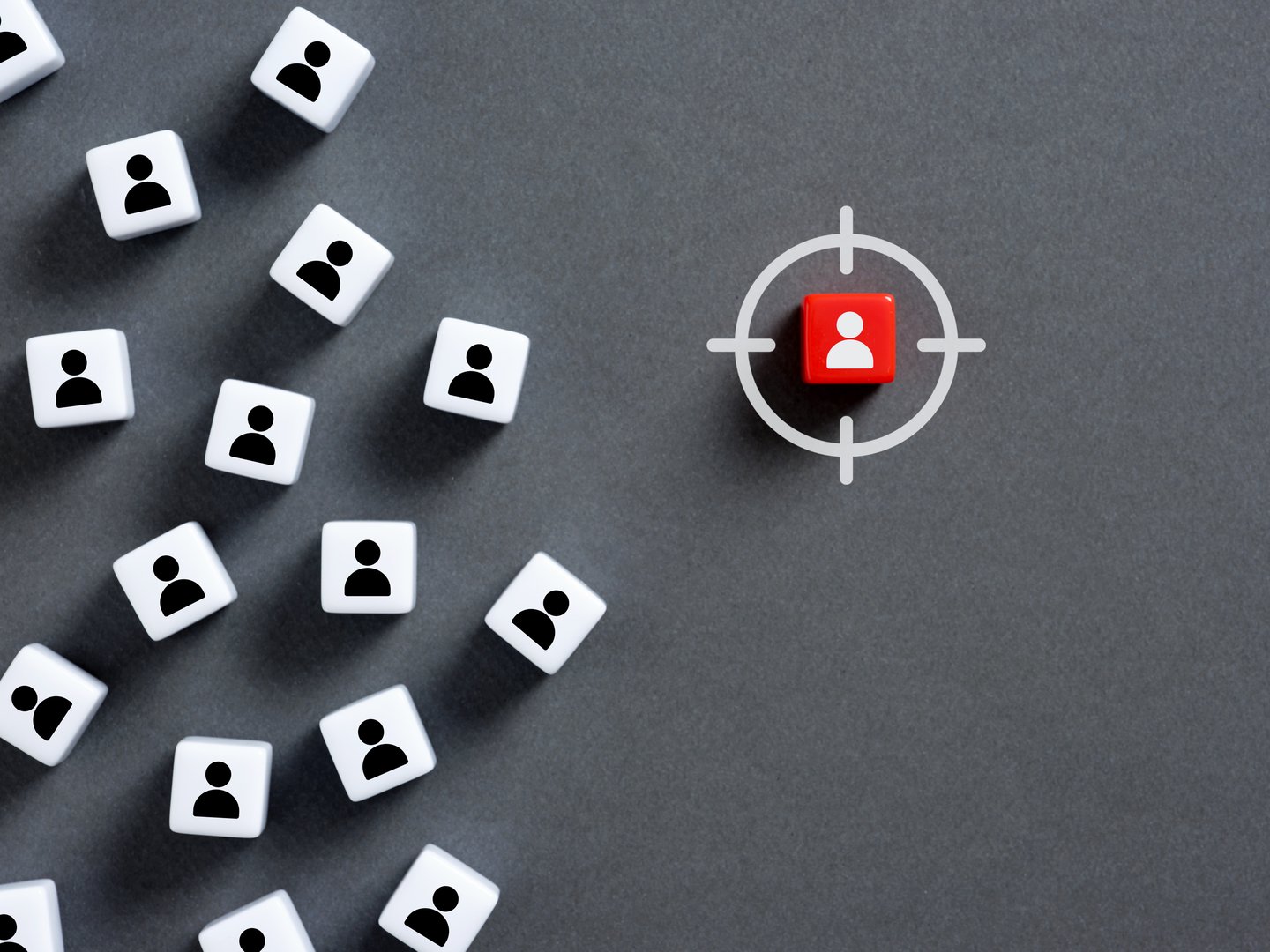 Targeting a specific candidate in a recruitment process, featuring a red dice encircled by a target, symbolizes strategic employee hiring efforts