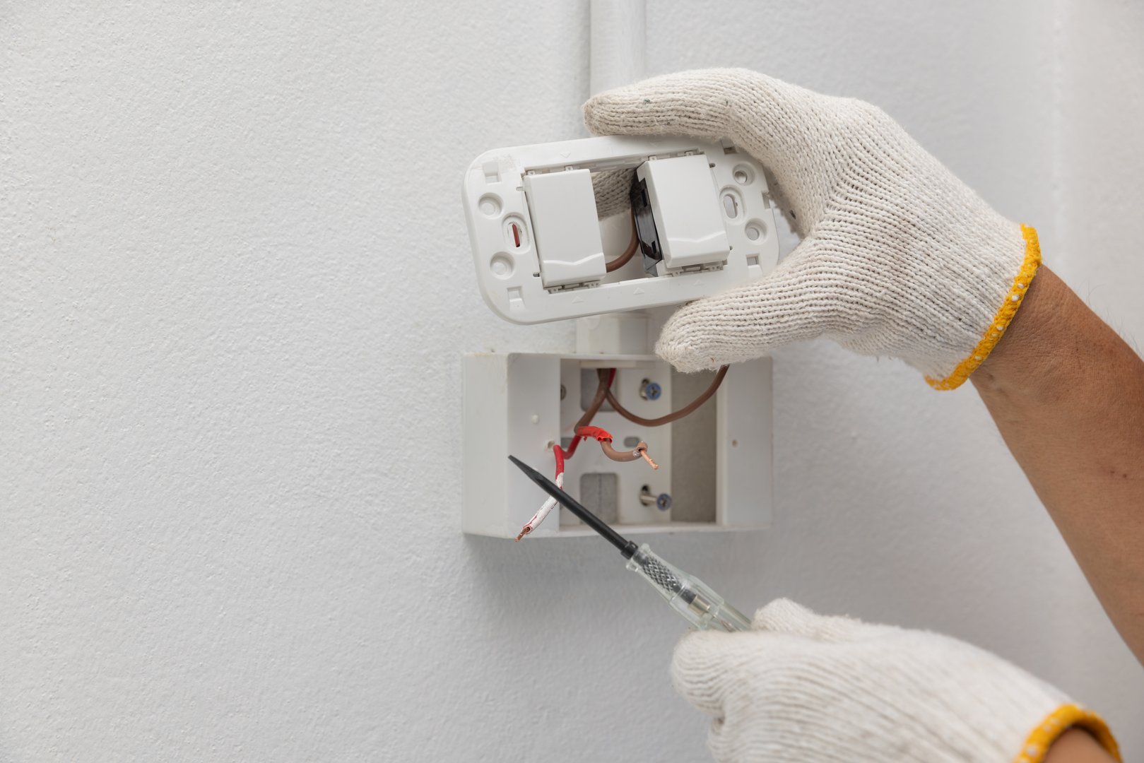 Handyman replace light wall switches in kitchen.