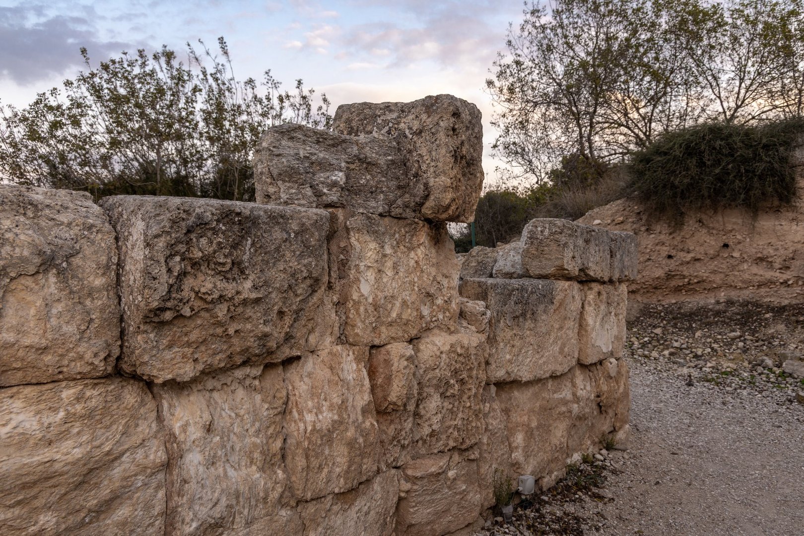 Weathered limestone blocks form a low fortress wall fragment at Zippori National Park in Galilee Israel