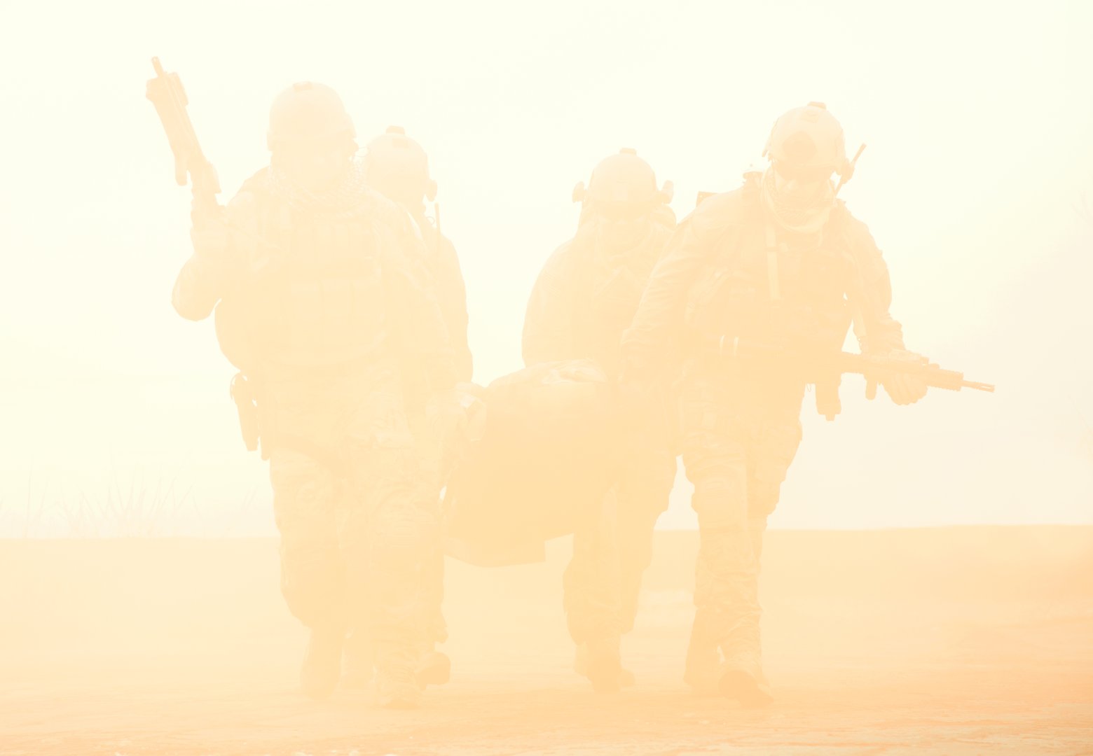 Squad of soldier evacuate the injured fellow in arms hiding in the smoke