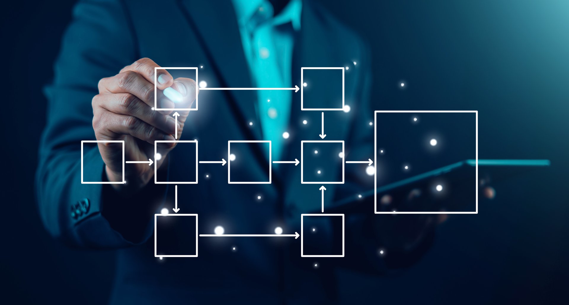 Businessman drawing virtual workflow diagram with connected boxes and arrows, digital process automation and business strategy concept