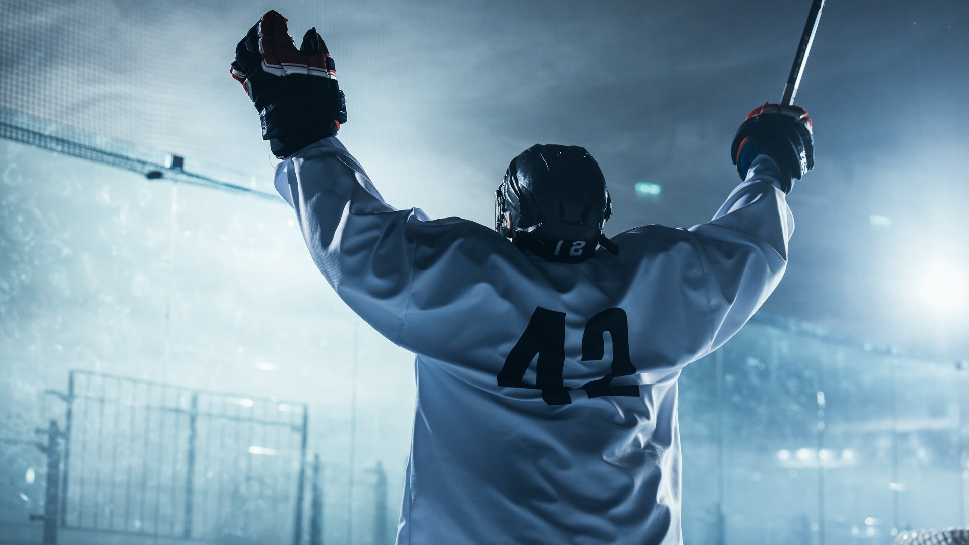 Professional Ice Hockey Player Celebrating Victory, Raising Arms.