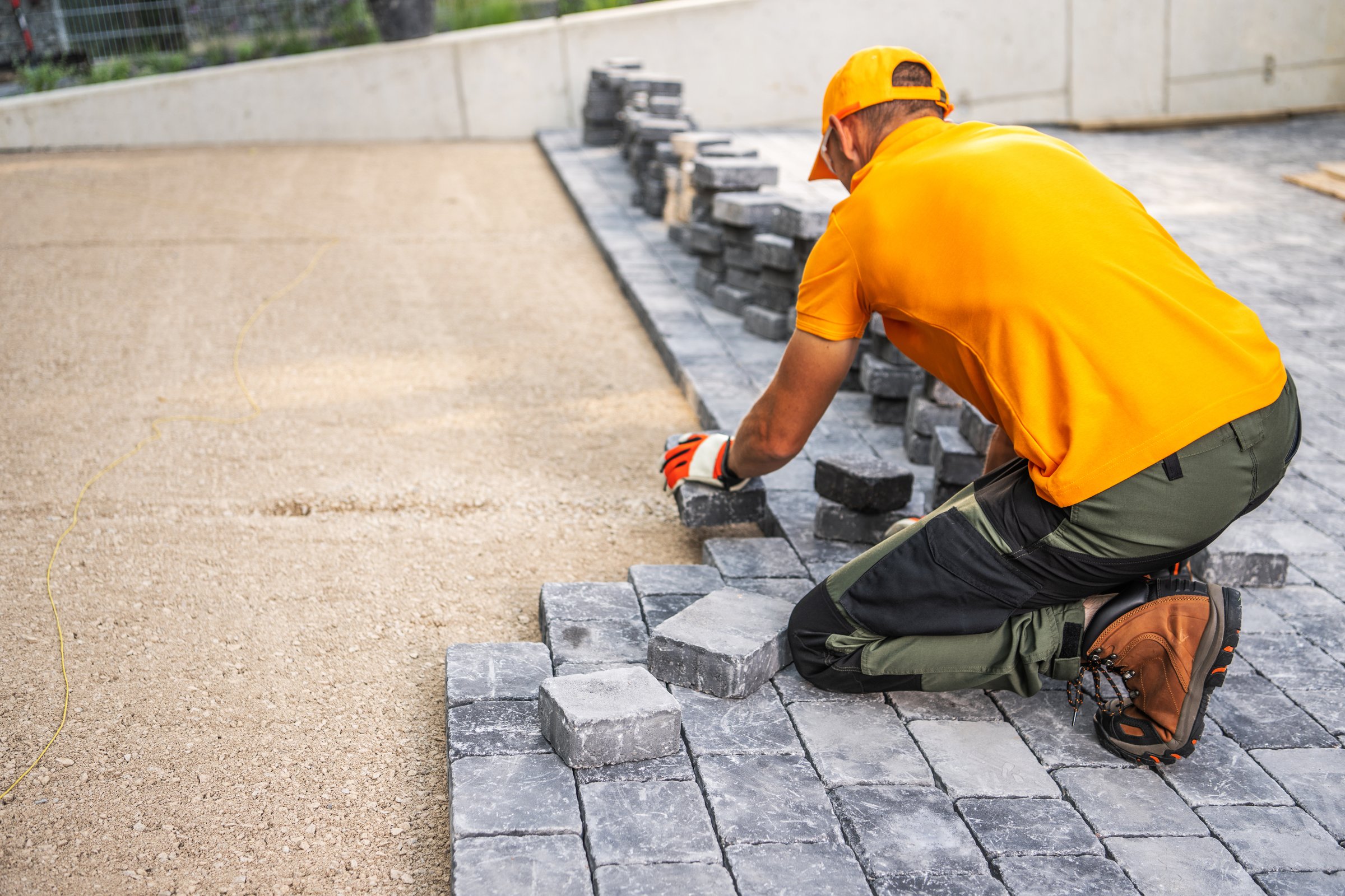 Construction worker laying cobblestones Sheffield