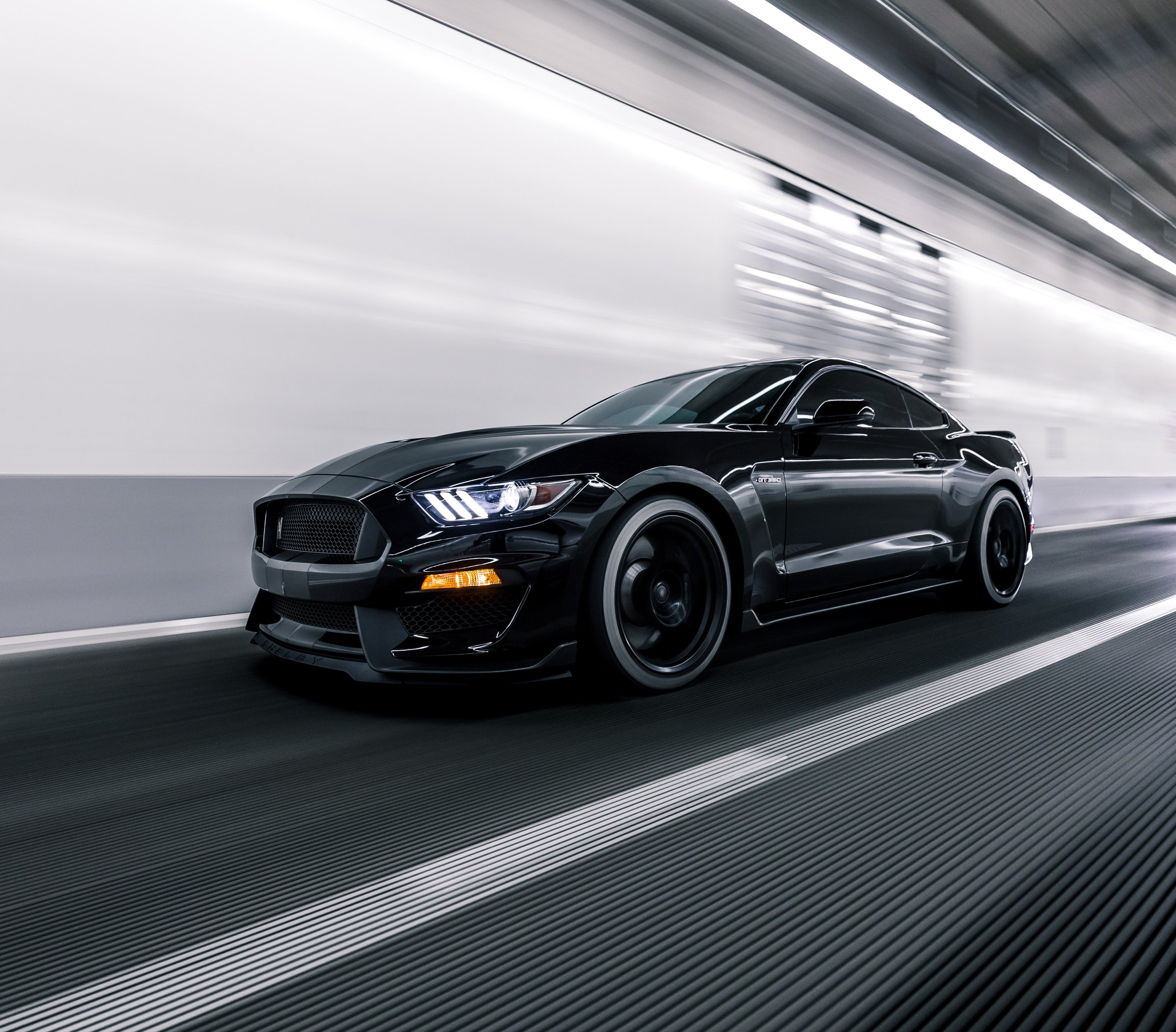 LA, CA, USA
4/13/2022
Shelby GT 500 in black driving on the road next to a white line