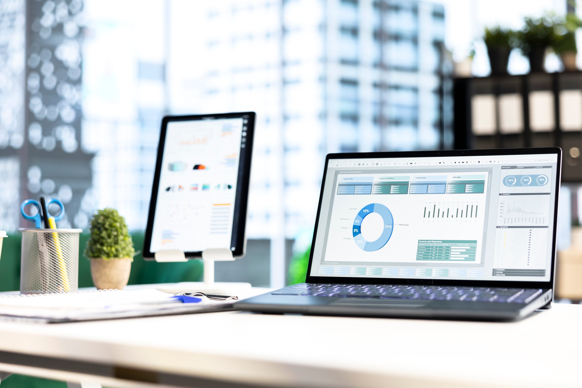 Modern work environment in a urban corporation downtown building, high end workspace with business analytics trends running on screen. Career development, office life. Close up.