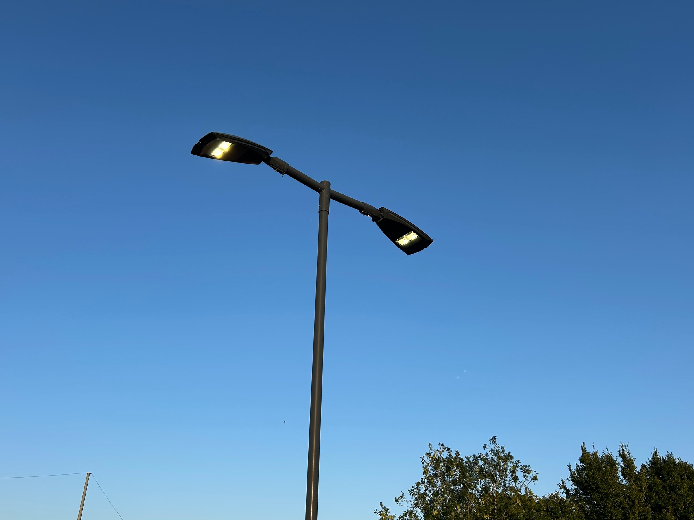 Modern Streetlight Illuminated Against a Clear Evening Sky