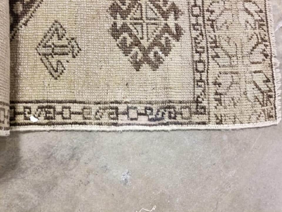 After: Professional rug damage repair with restored edges and fibers