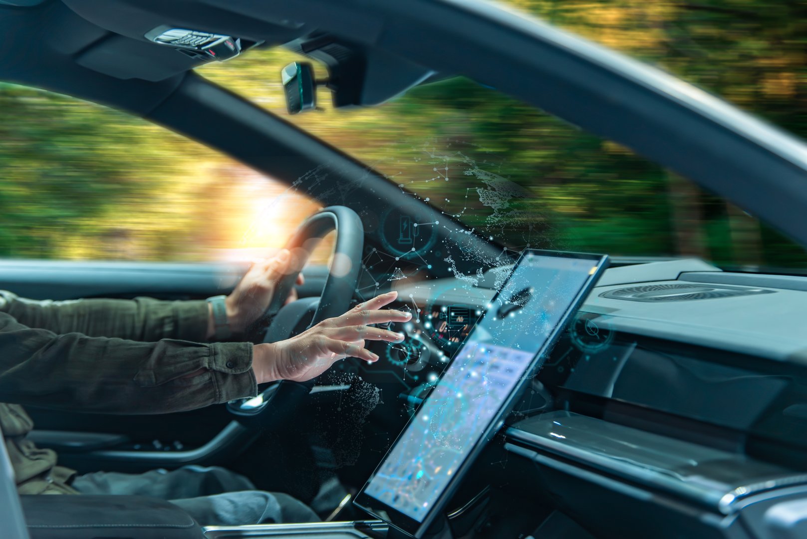 A person in a modern car interacts with a high-tech touchscreen interface displaying digital data overlays, representing smart vehicle technology.