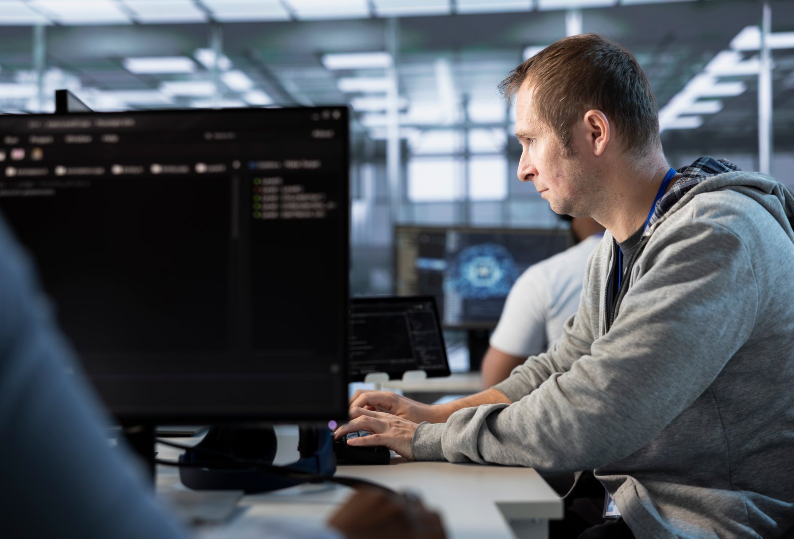 Man getting PC crash while trying to fix error in high tech data center workplace, solving tasks. Server farm worker trying to repair bugs in mainframes, typing on computer keyboard