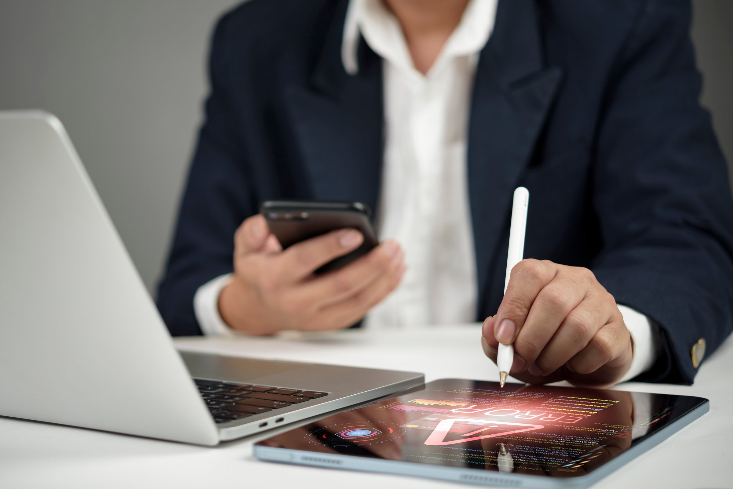 Business professional coding AI program on tablet with pen, integrating smartphone and laptop for innovation, big data, and digital transformation technology hacker cyber security concept.