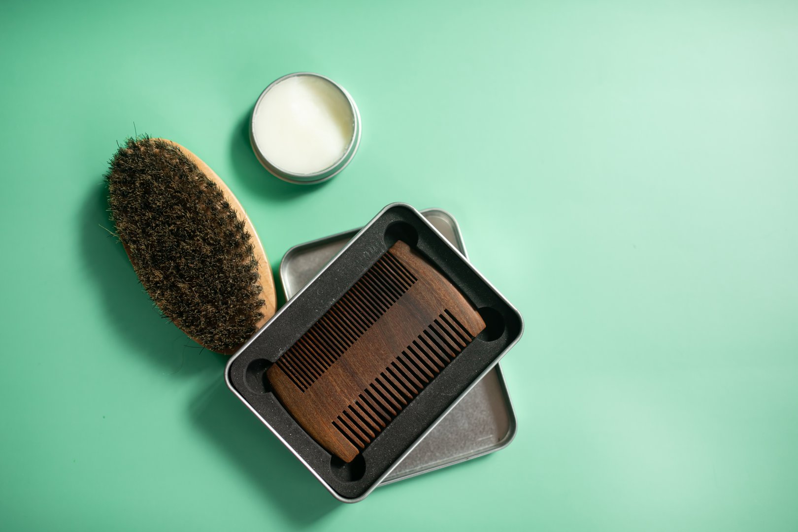 Close up view of beard kit with wax, comb and brush. Copy space.