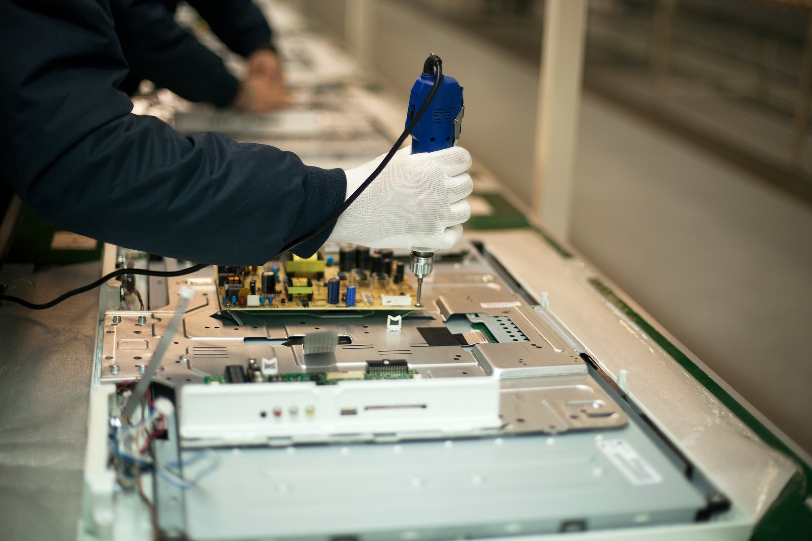 Manual worker at production line.