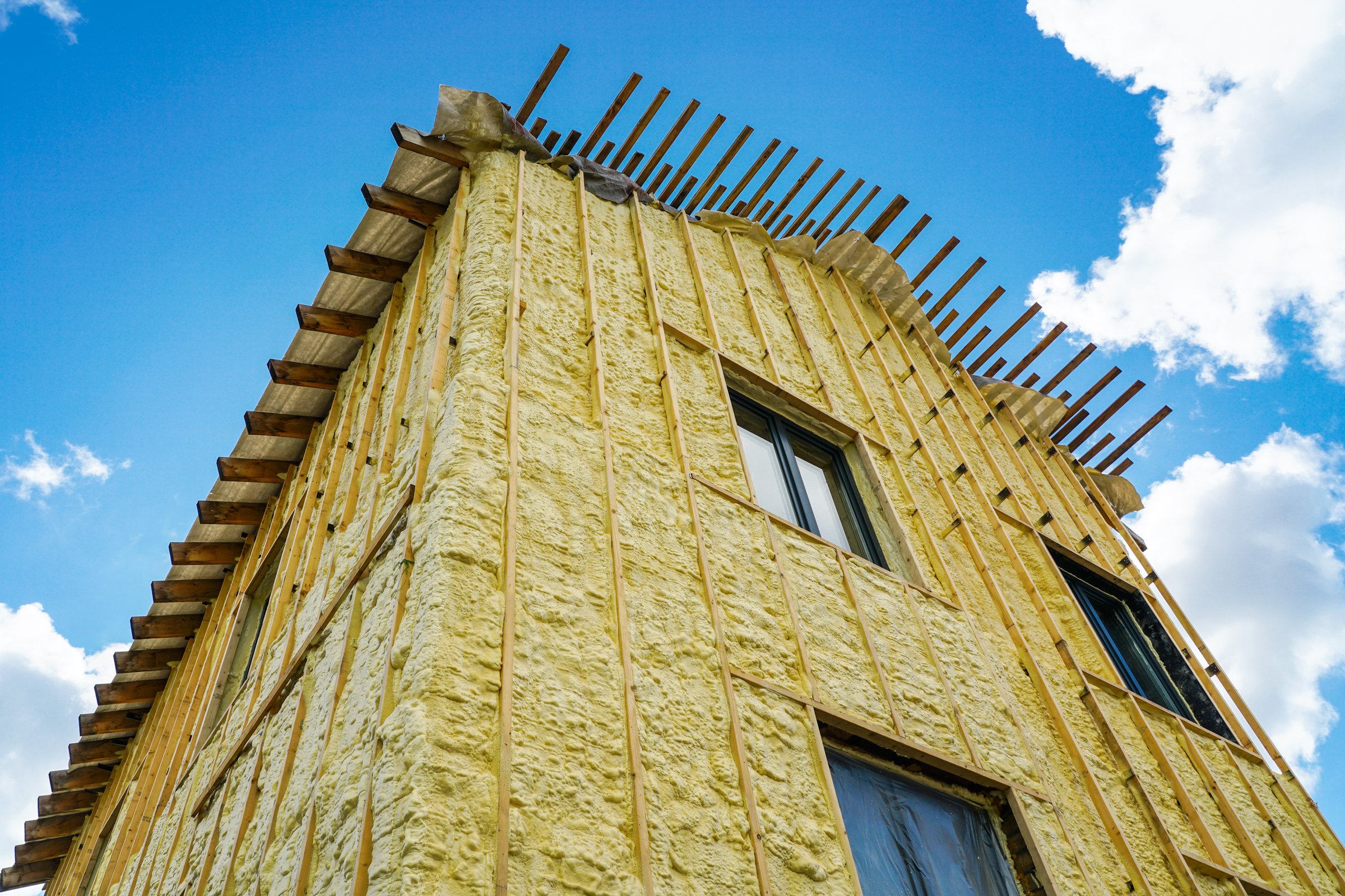 The facade of the residential house sprayed with a layer of polyurethane thermal insulation foam before siding