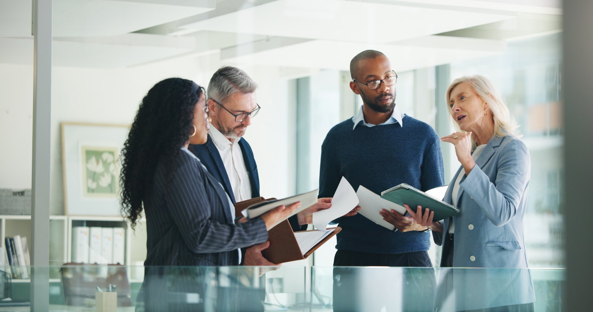 Business, documents and people with meeting discussion for finance trends, policy decision or update. Financial managers, report and feedback in office for investment strategy or risk management team