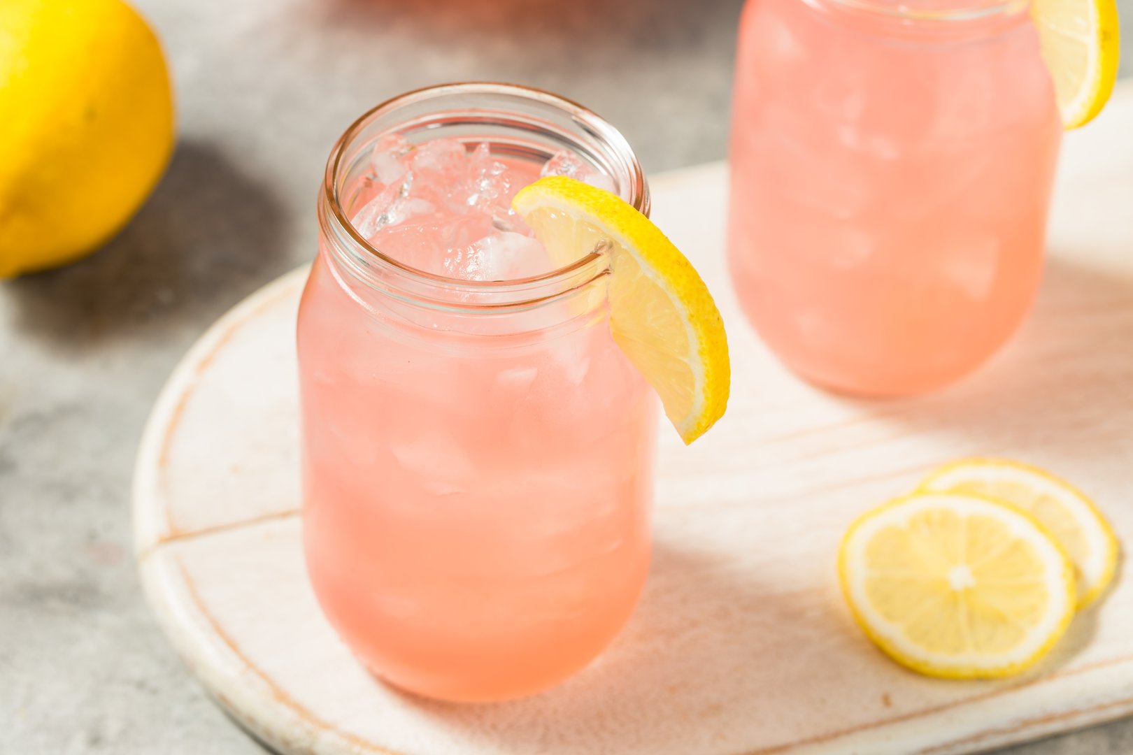 Refreshing Cold Iced Pink Lemonade Drink with Ice Cubes