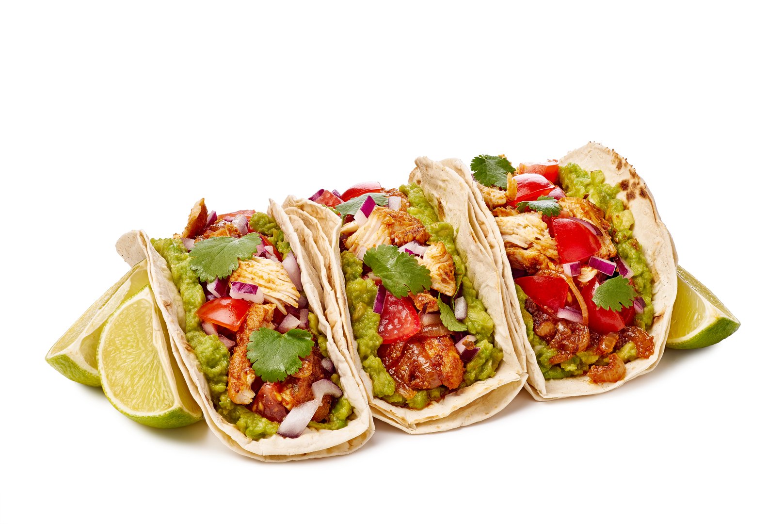 Indulge in a mouthwatering trio of delicious tacos filled with fresh vegetables, savory meat, and zesty lime