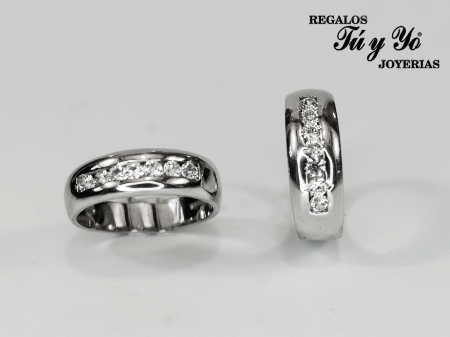 Two silver rings with embedded diamonds, displayed on a white background with 'Regalos Tú y Yo Joyerías' logo.