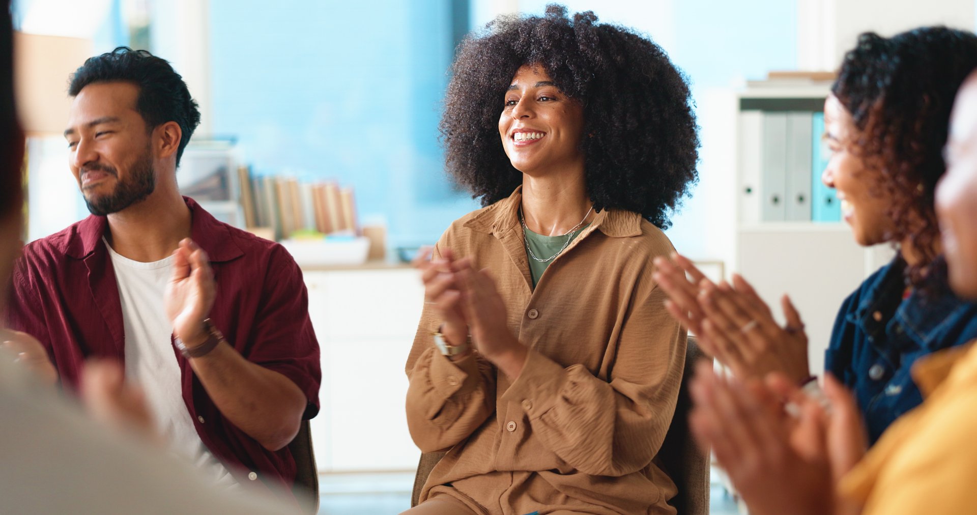 Excited people, support group and meeting with applause for congratulations, thank you or well done. Happy, team or employees clapping with smile for promotion, bonus or winning together in workplace