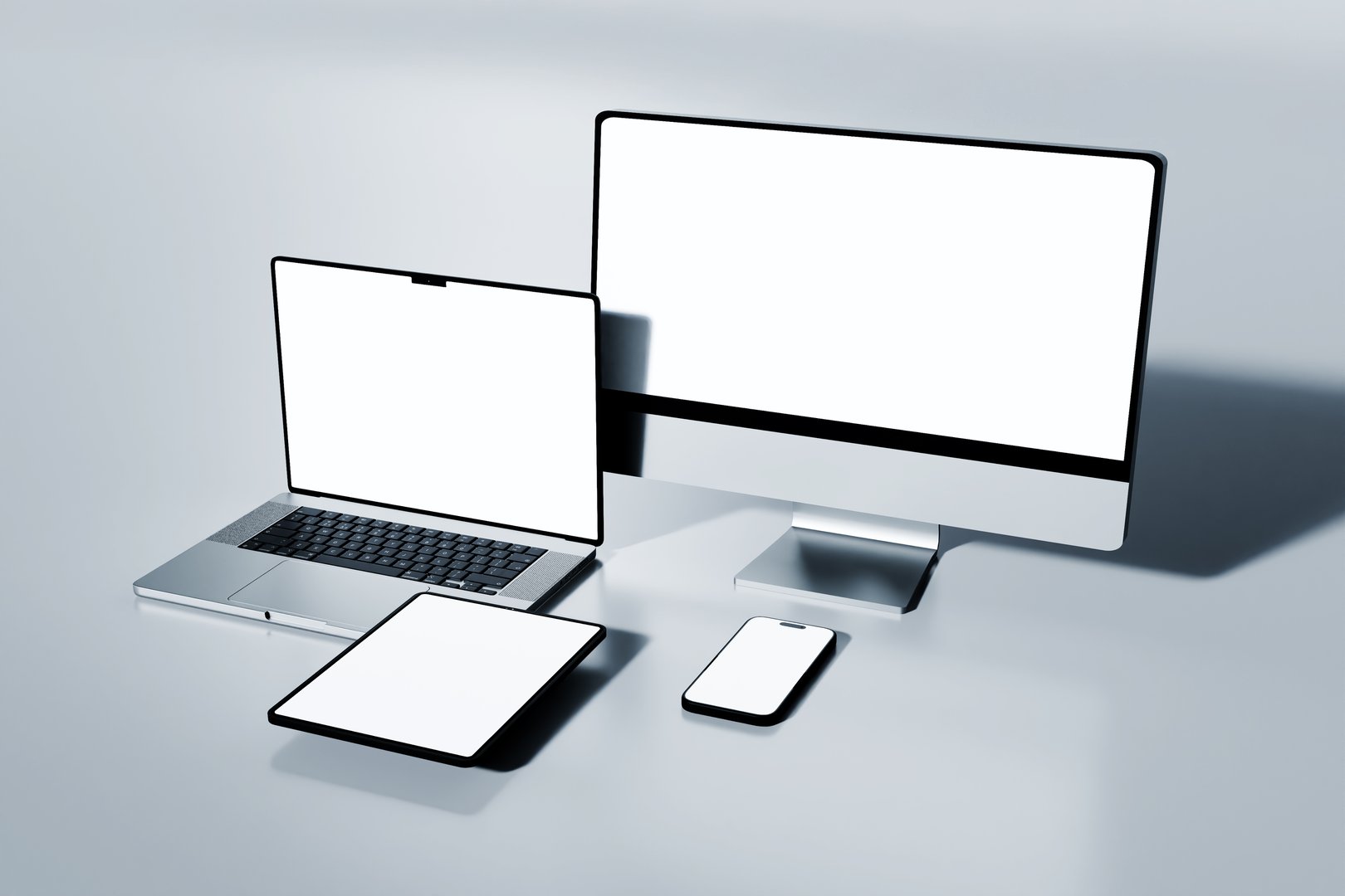 modern electronic devices smartphone, tablet, laptop, and desktop monitor with blank screen for mockup