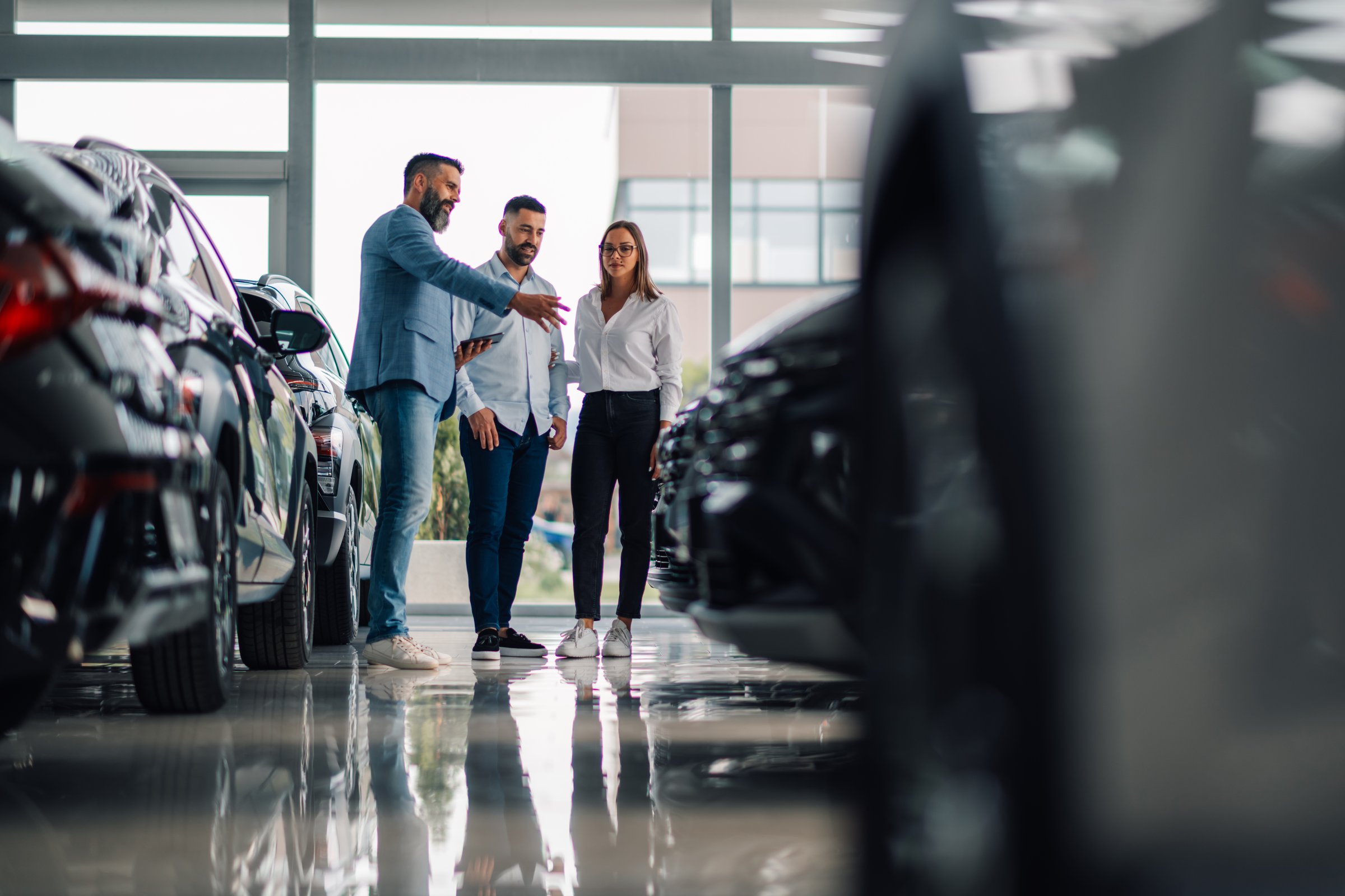 Dealer discussing car options with customers
