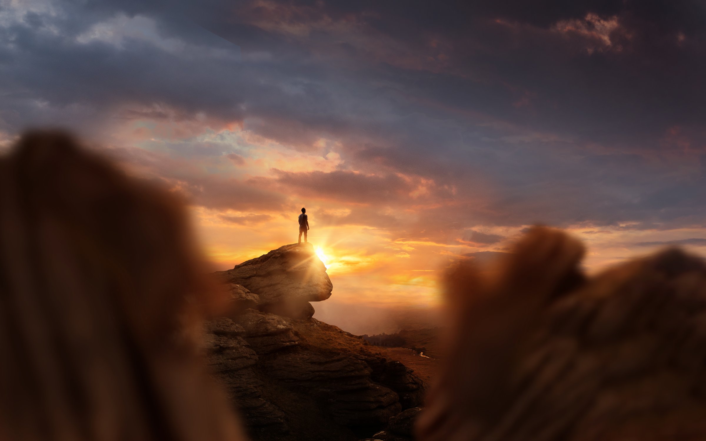 Leadership And Goals. A man standing on top of a mountain at sunset. Conceptual photo composite.