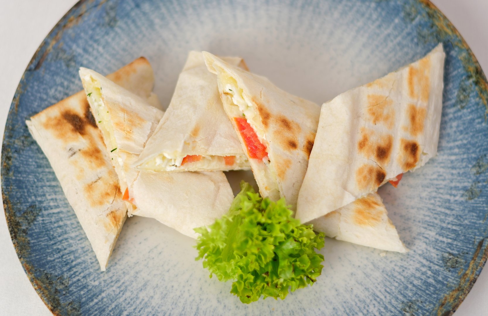 with cheese and tomato lavash Shawarma sandwich gyro fresh roll of lavash pita bread cheese. Traditional Middle Eastern snack.