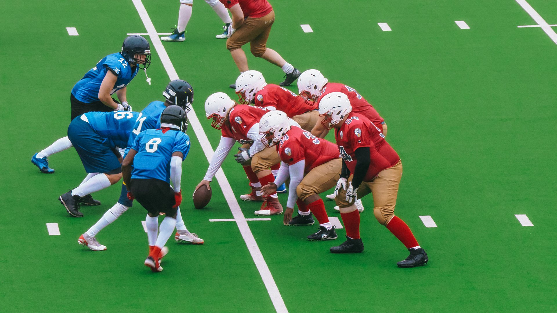 Two Diverse Athletic Teams Take Their Positions at The Start of the Tournament Game. The Ball is Ready to Start the Game. Players Prepare to Run Forward While the Opposing Team Attempts to Stop Them