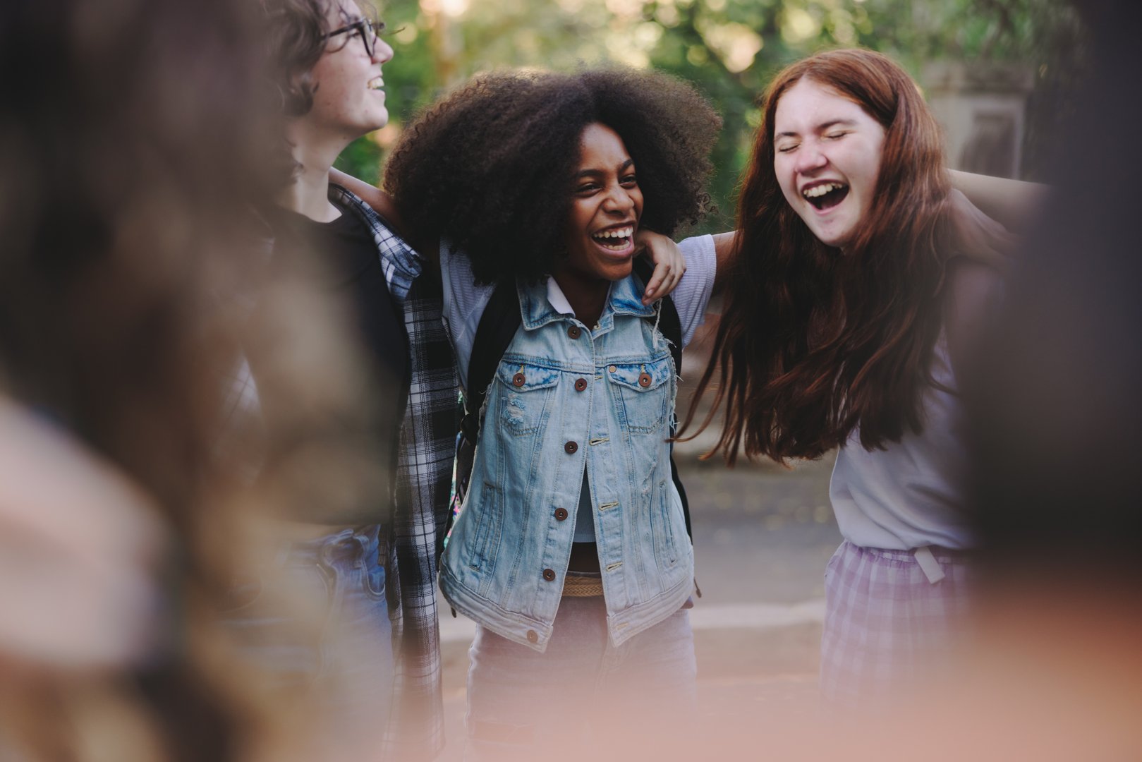Black teenage girls holding hands in unity and support