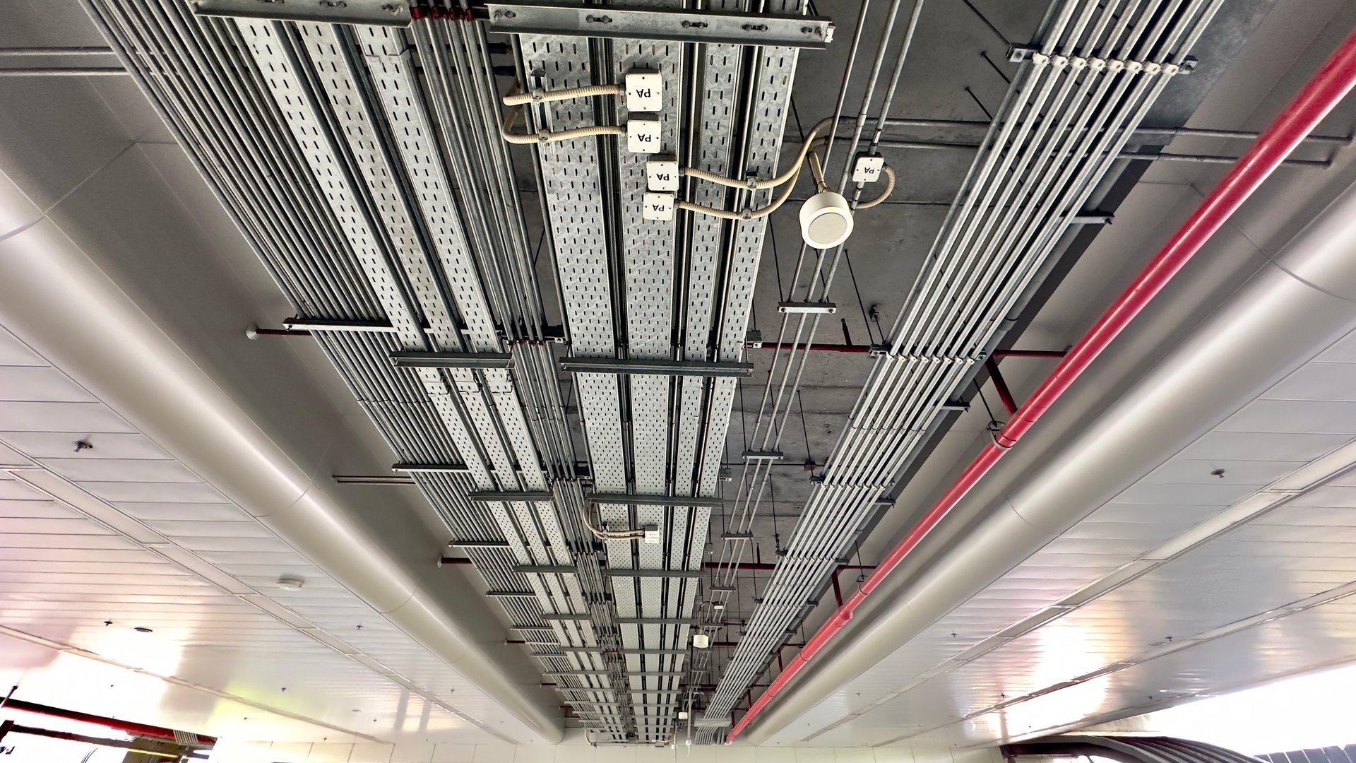 The installation of electrical conduits, cable trays, and fire pipes at the train station in Thailand.