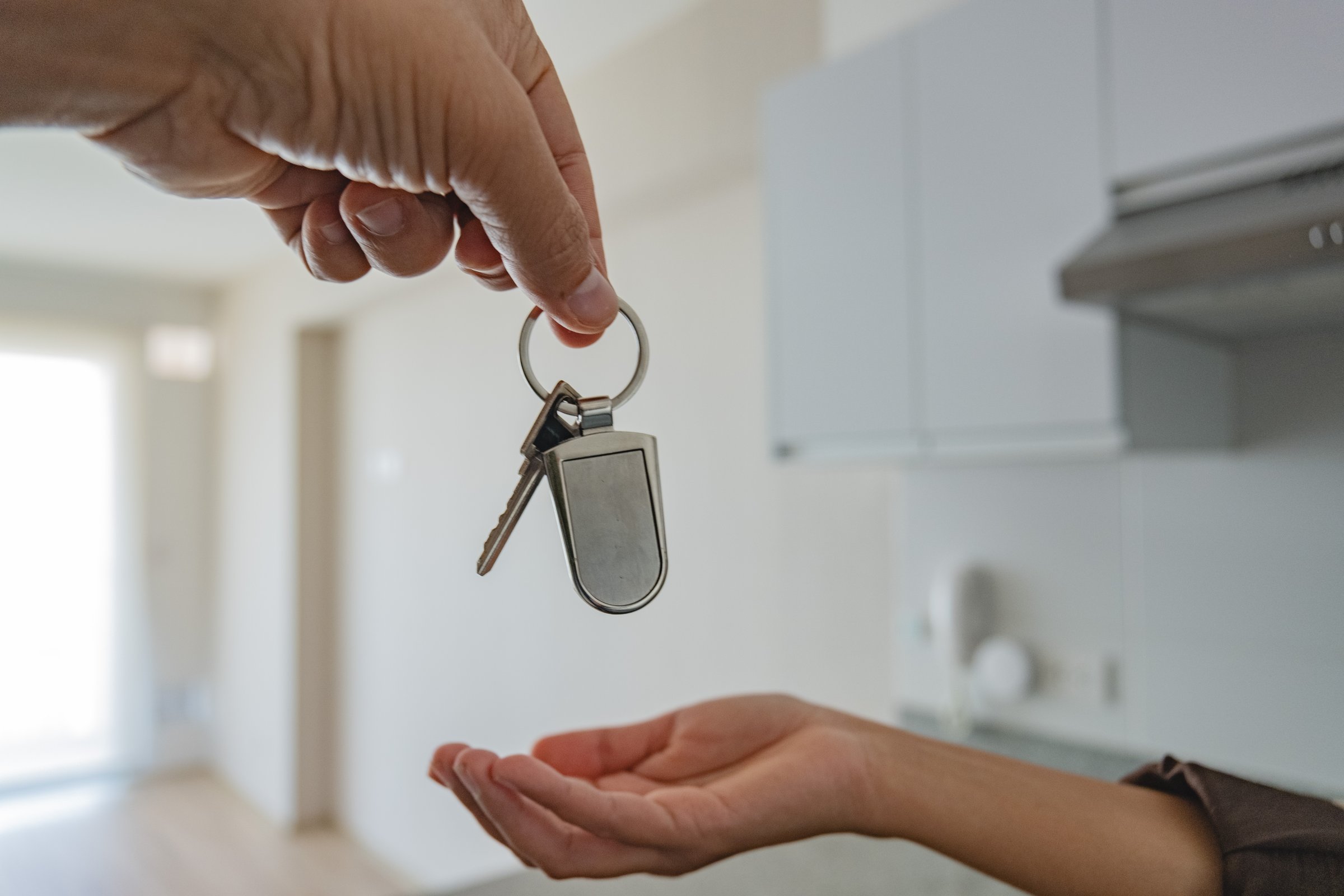 Landlord handing key to tenant - professional property management