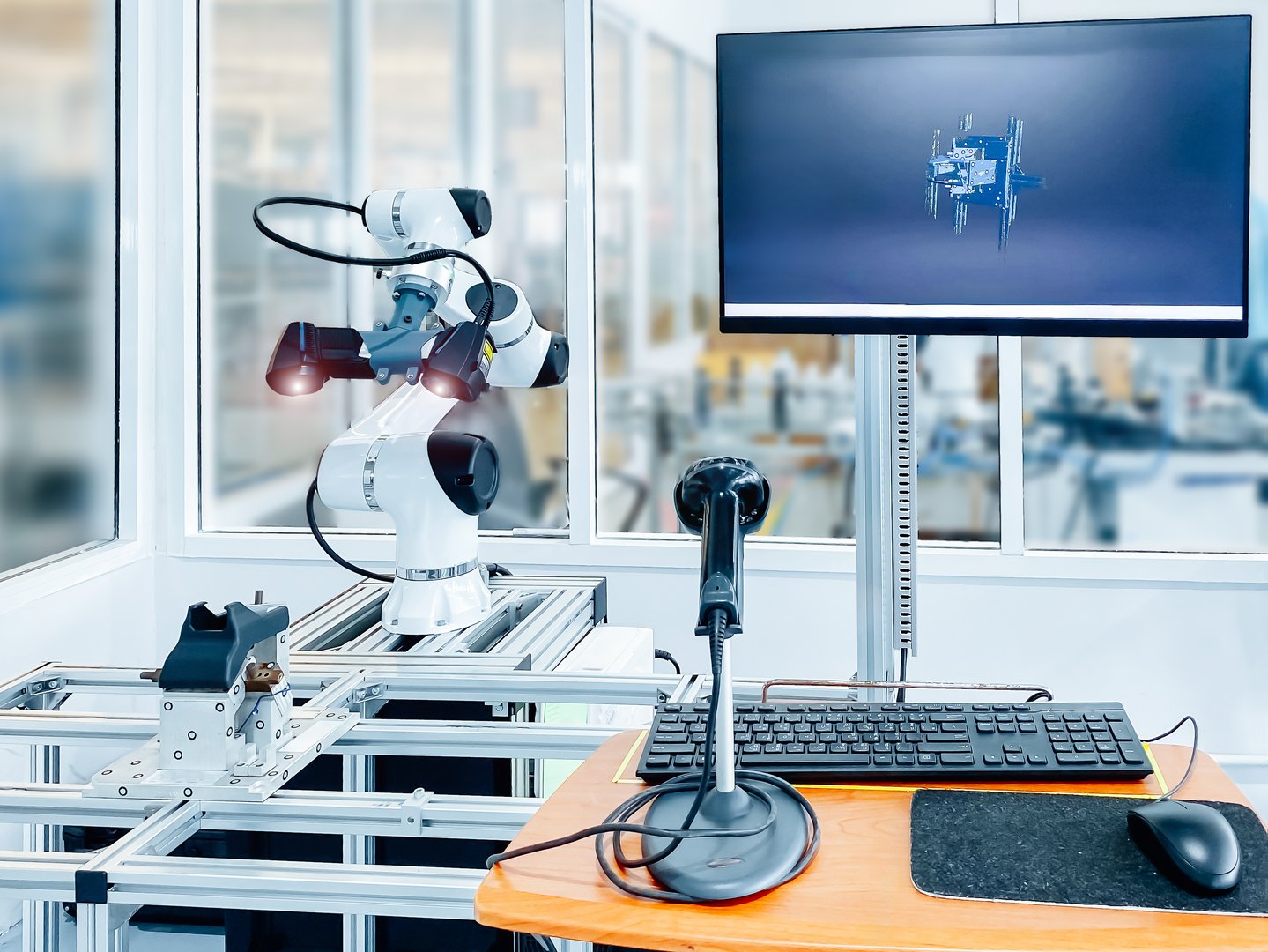 Robotic arm equipped with high-tech 3D scanner in an advanced manufacturing facility. Precision and automation in industrial technology.