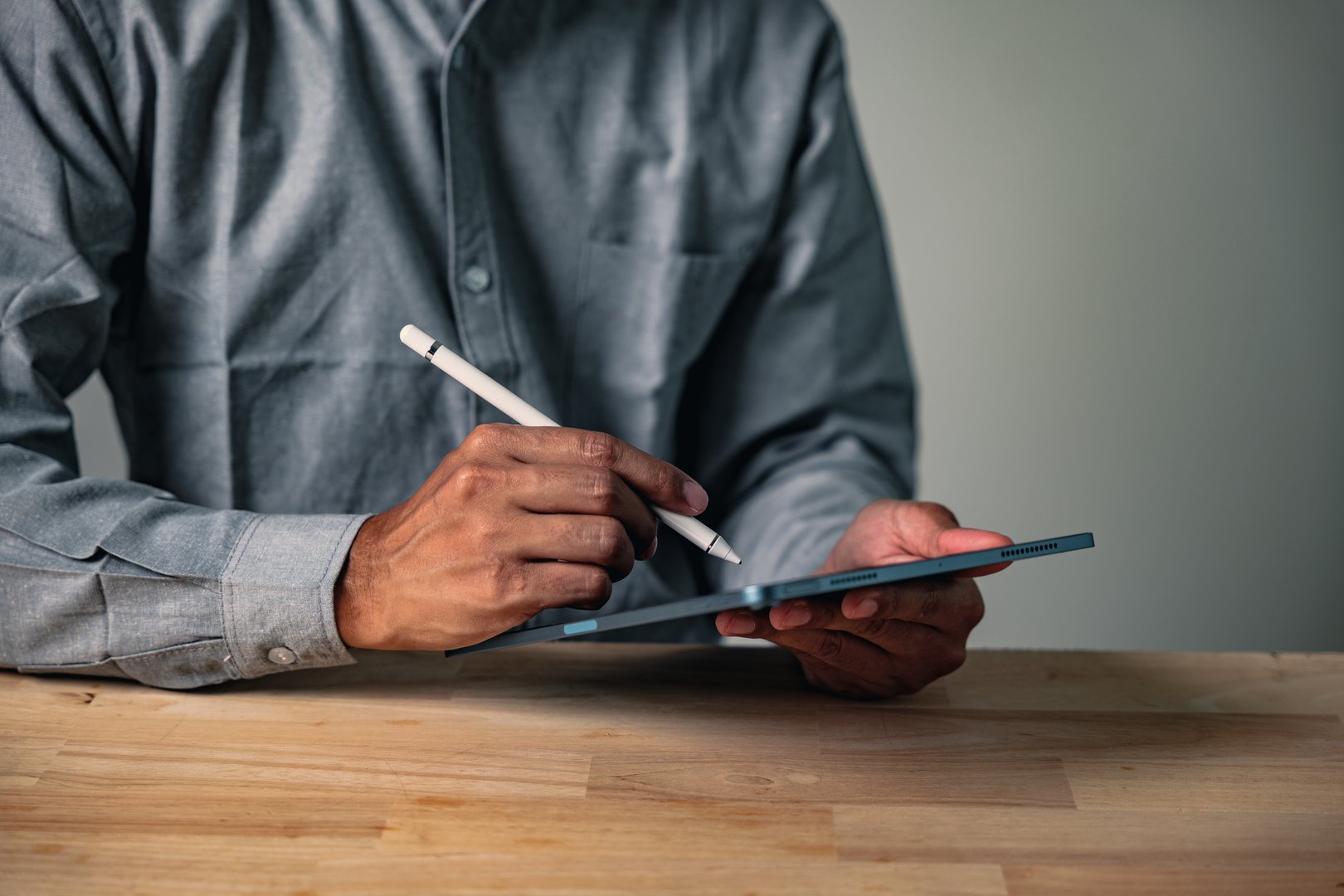 African professional man using tablet and stylus for work presentation