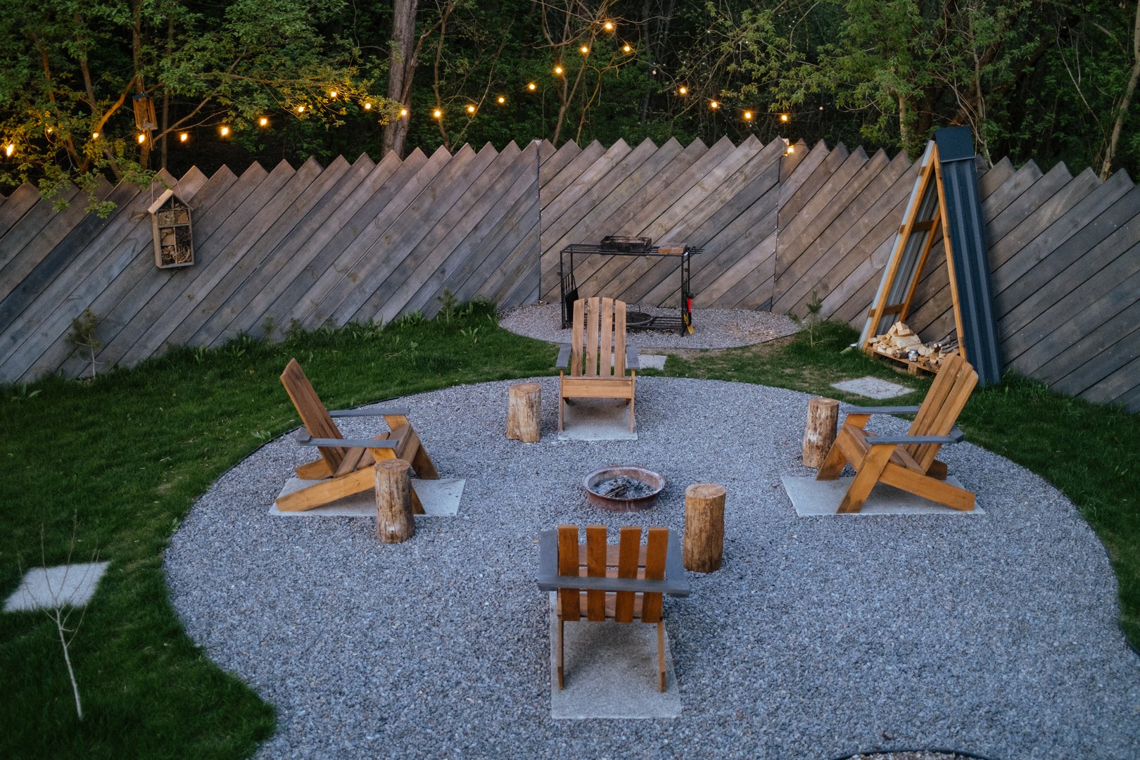 Gravel patio with rustic seating and fire pit