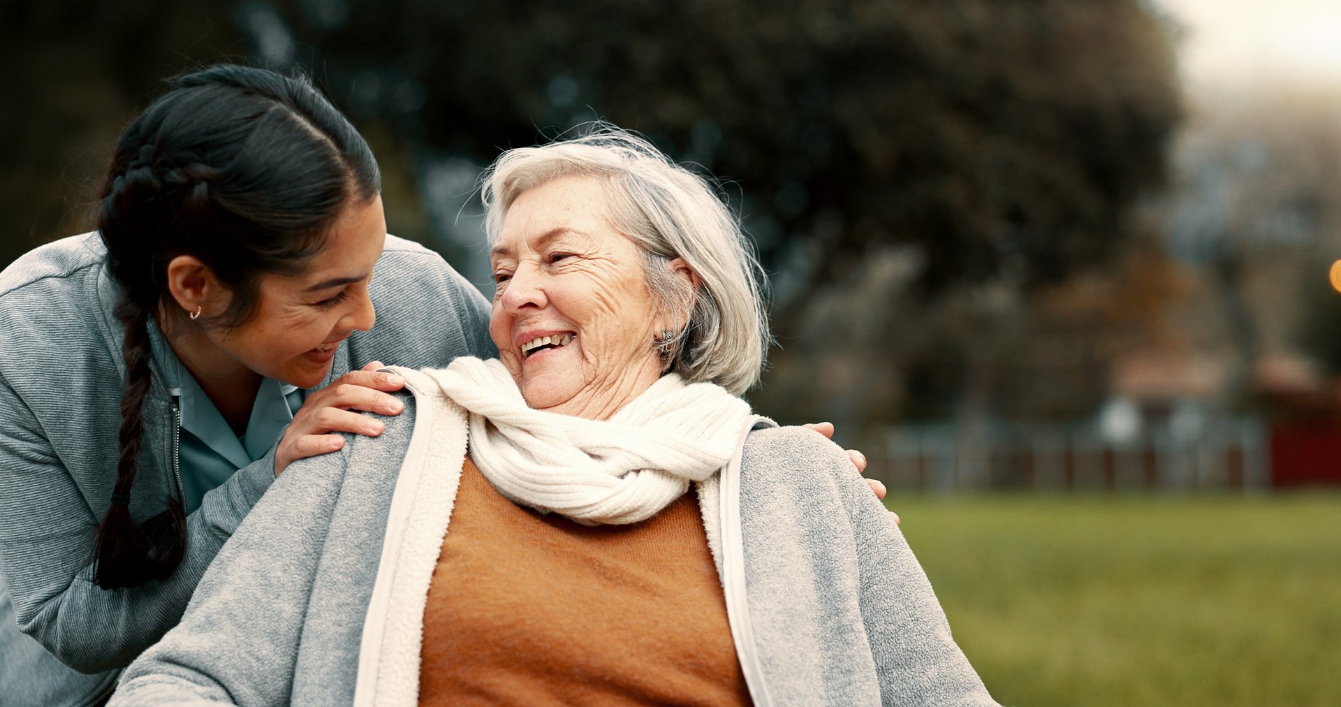 Caregiver supporting person with disability in park