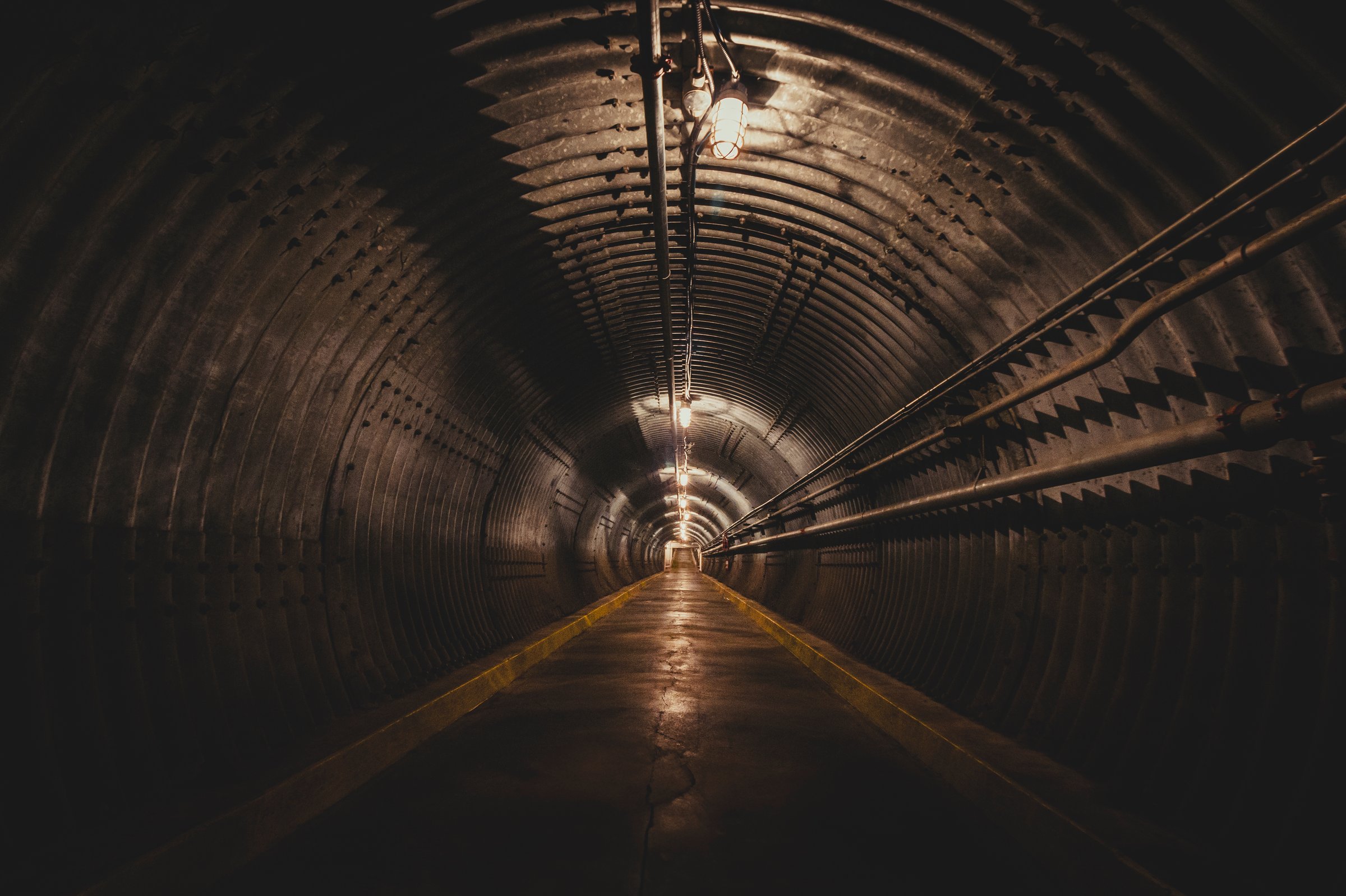 Photo of an empty underground cement entrance to a nuclear blast shelter.