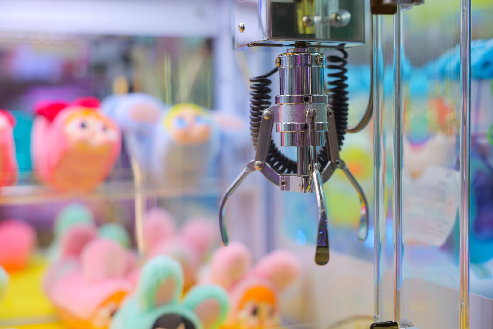 A Colorful Claw Machine Filled with Soft Plush Toys and Fun Offers.