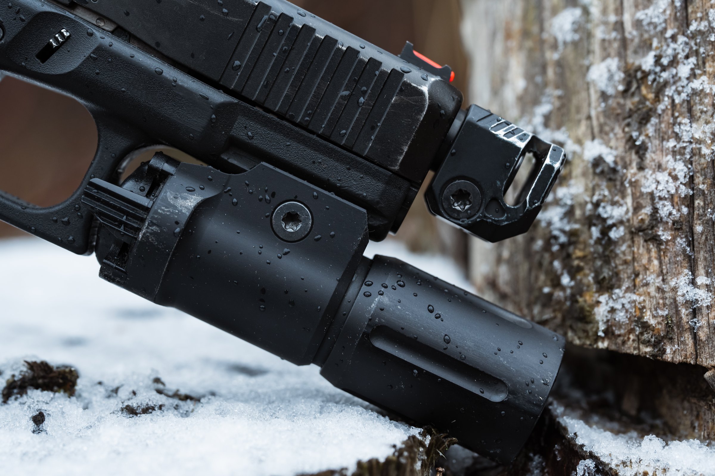Tactical gear, powerful weapon flashlight mounted on a pistol, macro photo.