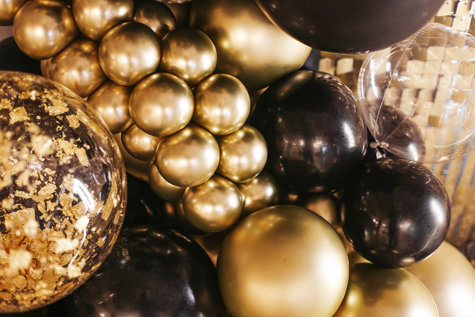 Shiny balloon backdrop for New Year's Eve celebrations and photo shoots. Glittering ornament.