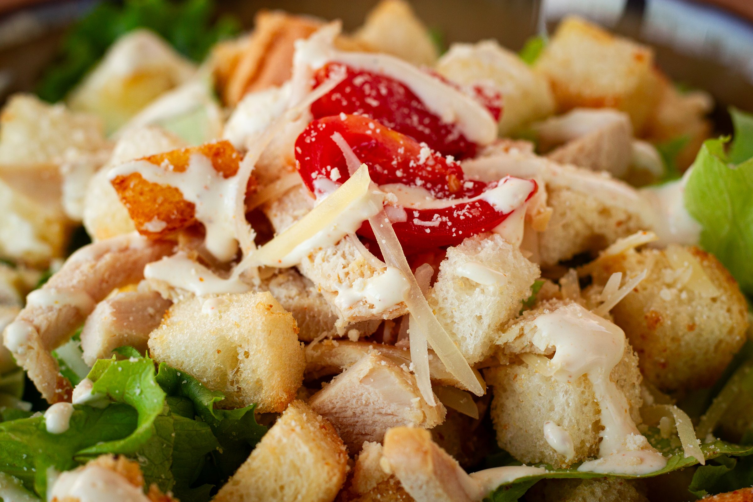 classic Caesar salad, close-up, natural light, selective focus, horizontal,