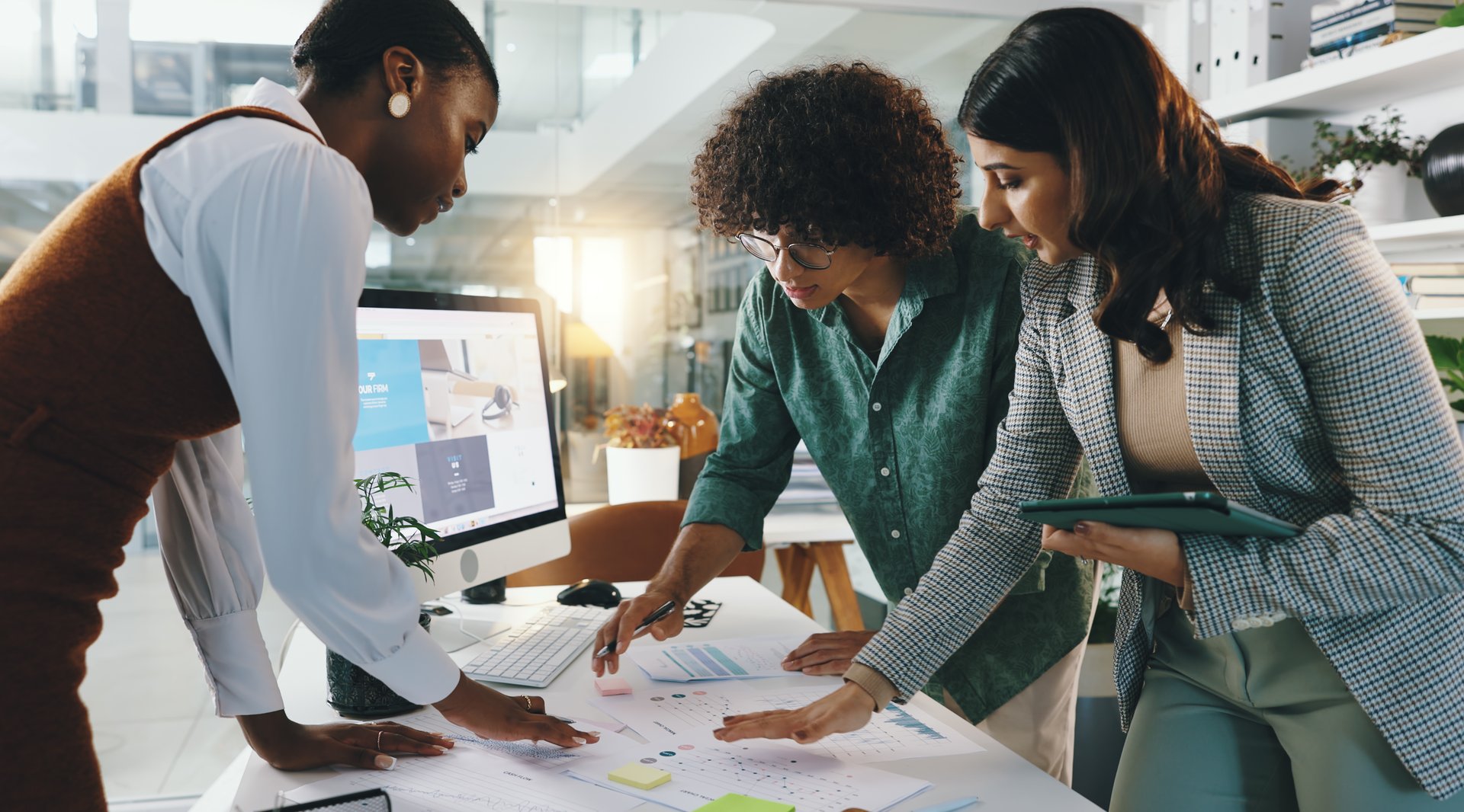 People, meeting and paper in office for business, project finance and budget planning at tech. Designer, team and discussion in digital agency for brainstorming, web design and creative collaboration
