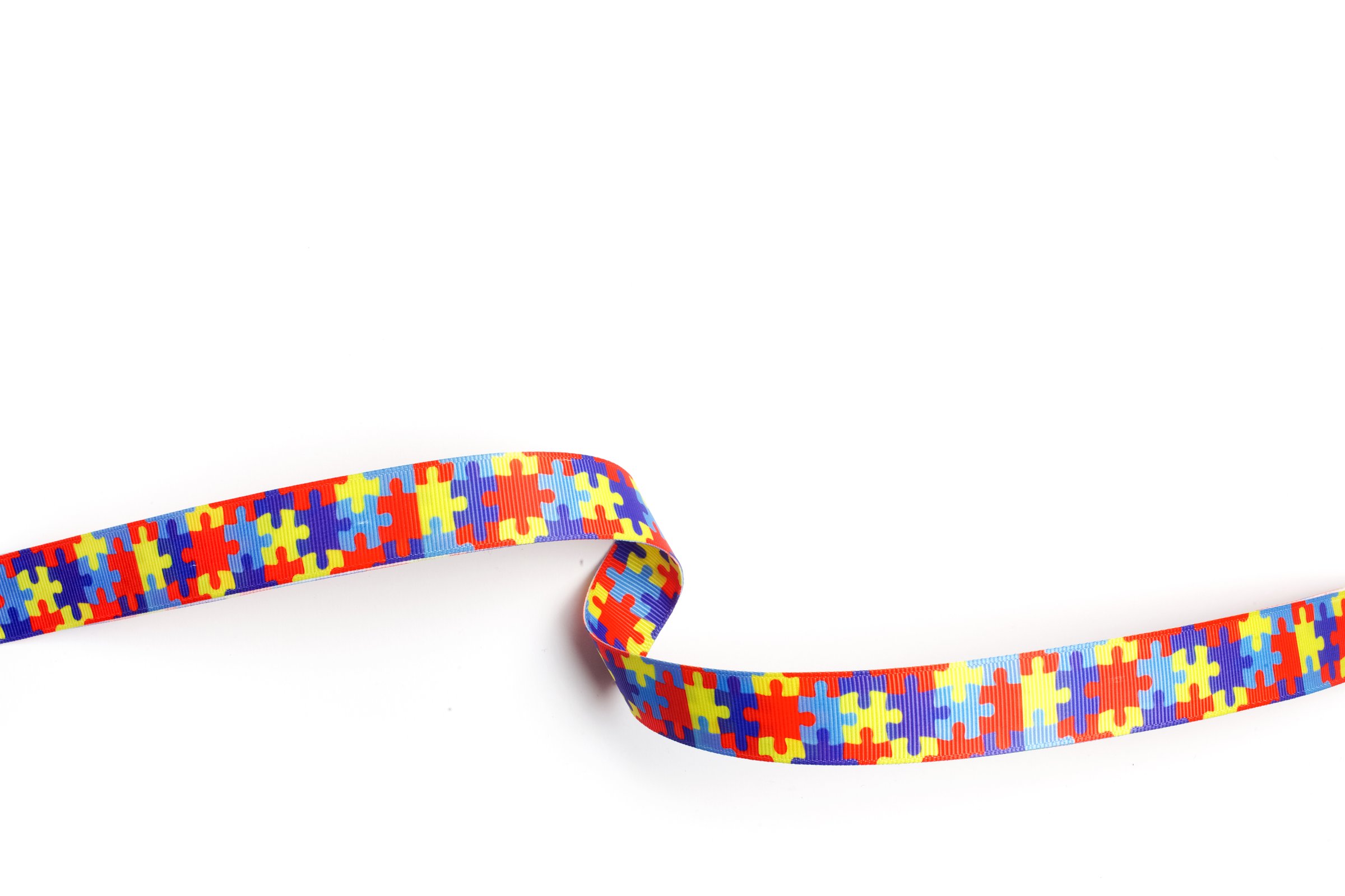World Autism awareness and pride day with Puzzle pattern ribbon on white background