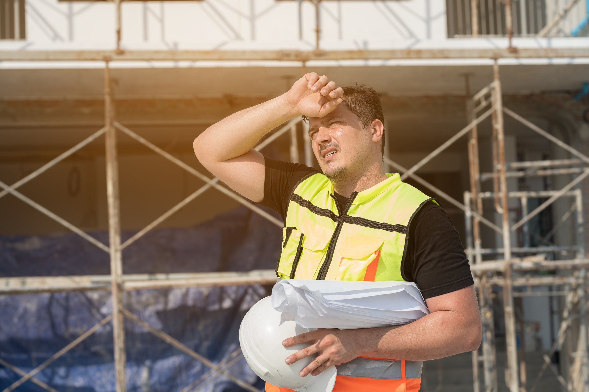 Male construction engineer worker working feeling tired and thirst of water at construction site