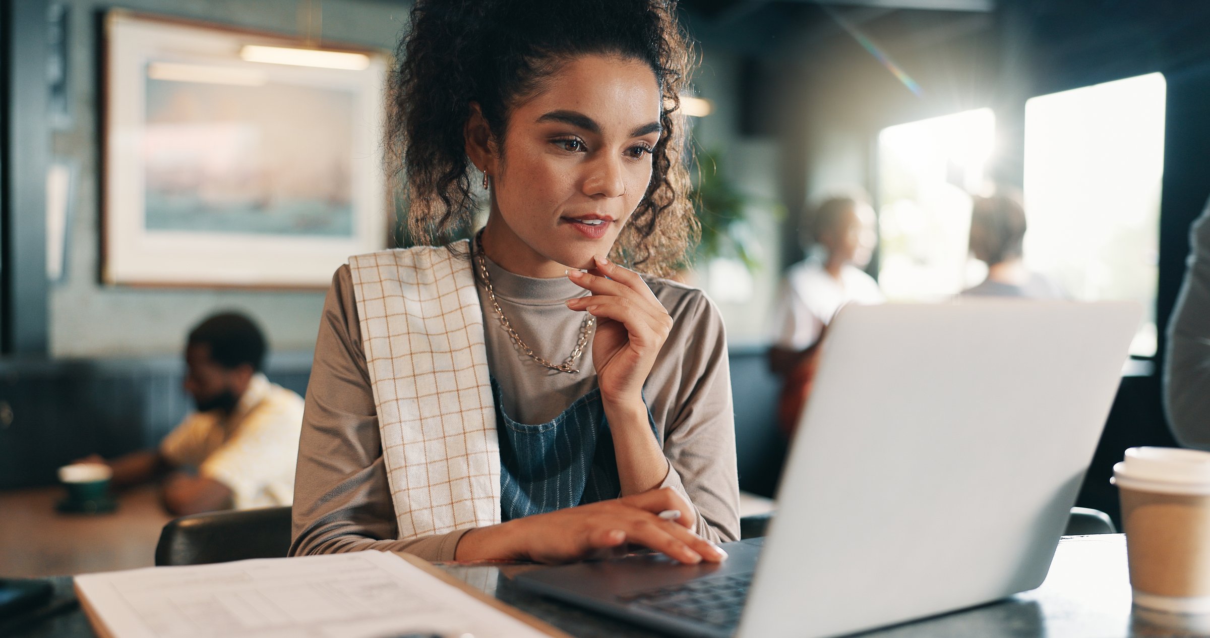 Business owner, thinking and woman in restaurant, laptop and problem solving for inventory. Person, employee or barista in coffee shop, tech or online reading for review, decision or report for sales