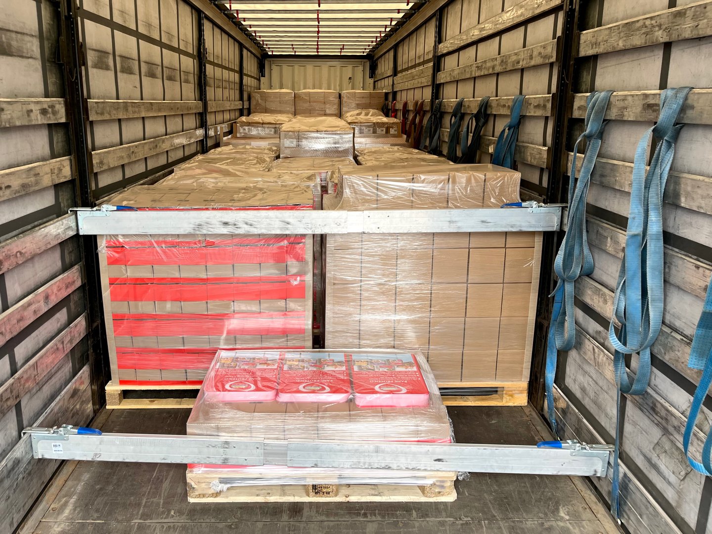 Transportation of cardboard and wooden cargo in a semi-trailer truck.